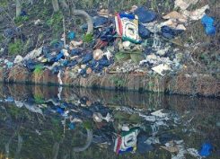 fly-tipping-at-a-river-reflecting-waste